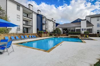 Refreshing swimming pool with lounge deck  & umbrellas